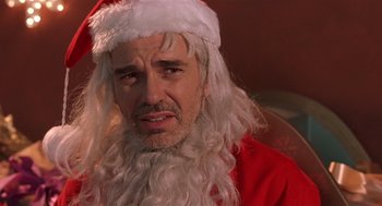 Movie still from “Bad Santa” (2003), directed by Terry Zwigoff – A person wearing a santa claus costume; Close Up shot, Over the shoulder angle