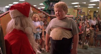 Movie still from “Bad Santa” (2003), directed by Terry Zwigoff – A boy is standing in front of a santa clause; Medium shot, Over the shoulder angle