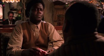 Movie still from “Bad Santa” (2003), directed by Terry Zwigoff – A man sitting in front of another man in front of a mirror; Close Up shot, Over the shoulder angle