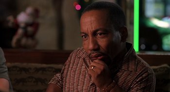 Movie still from “Bad Santa” (2003), directed by Terry Zwigoff – A person with his hand on his chin; Close Up shot, Low angle