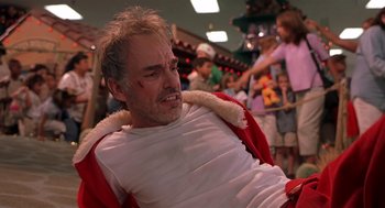 Movie still from “Bad Santa” (2003), directed by Terry Zwigoff – A man in a white t - shirt and a red jacket; Close Up shot, Low angle