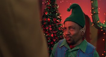 Movie still from “Bad Santa” (2003), directed by Terry Zwigoff – A man wearing a green elf hat and a green shirt; Close Up shot, Low angle