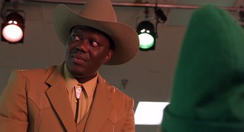 Movie still from “Bad Santa” (2003), directed by Terry Zwigoff – A man wearing a cowboy hat and a suit; Close Up shot, Low angle