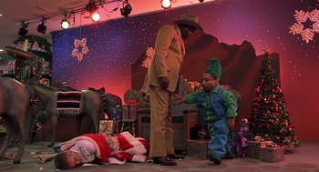A man and a boy dressed up as a christmas elf