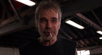 Movie still from “Bad Santa” (2003), directed by Terry Zwigoff – A person smoking a cigarette; Close Up shot, Low angle