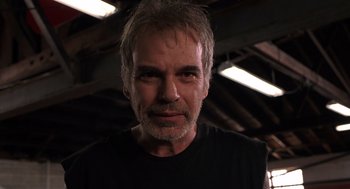 Movie still from “Bad Santa” (2003), directed by Terry Zwigoff – A person wearing a black t - shirt; Close Up shot, Low angle