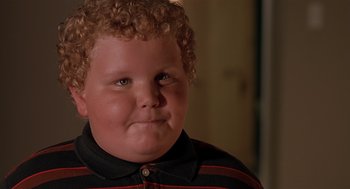 Movie still from “Bad Santa” (2003), directed by Terry Zwigoff – A person with curly red hair; Close Up shot, High angle