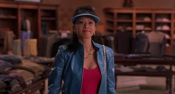 Movie still from “Bad Santa” (2003), directed by Terry Zwigoff – A woman wearing a blue jacket and a blue hat; Medium shot, Over the shoulder angle