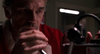 Movie still from “Bad Santa” (2003), directed by Terry Zwigoff – A person wearing a santa clause suit; Close Up shot, Low angle