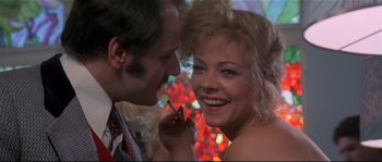 Movie still from “Bad Timing: A Sensual Obsession” (1980), directed by Nicolas Roeg – A man and a woman smiling at each other; Close Up shot, Over the shoulder angle