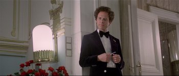 Movie still from “Bad Timing: A Sensual Obsession” (1980), directed by Nicolas Roeg – A man in a tuxedo standing in front of a mirror; Medium shot, Low angle