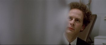 Movie still from “Bad Timing: A Sensual Obsession” (1980), directed by Nicolas Roeg – A man in a white shirt and tie looking at the camera; Close Up shot, Low angle