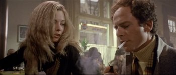 Movie still from “Bad Timing: A Sensual Obsession” (1980), directed by Nicolas Roeg – A man and a woman smoking a cigarette in front of a window; Close Up shot, Low angle