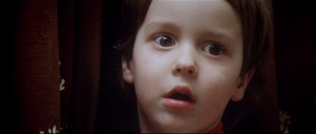 Movie still from “Bad Timing: A Sensual Obsession” (1980), directed by Nicolas Roeg – A young child's face; Extreme Close Up shot, Low angle