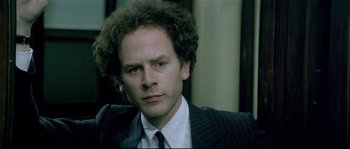 Movie still from “Bad Timing: A Sensual Obsession” (1980), directed by Nicolas Roeg – A person wearing a suit and tie; Close Up shot, Over the shoulder angle