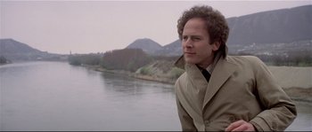 Movie still from “Bad Timing: A Sensual Obsession” (1980), directed by Nicolas Roeg – A man standing next to a body of water; Close Up shot, Low angle