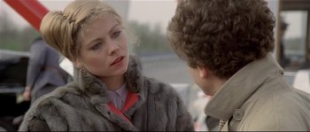 Movie still from “Bad Timing: A Sensual Obsession” (1980), directed by Nicolas Roeg – A woman wearing a fur coat talking to a man; Close Up shot, Over the shoulder angle