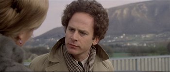 Movie still from “Bad Timing: A Sensual Obsession” (1980), directed by Nicolas Roeg – A person with curly hair wearing a coat; Close Up shot, Low angle