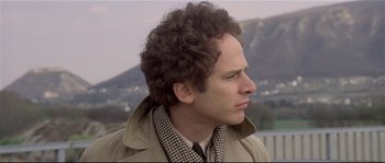 Movie still from “Bad Timing: A Sensual Obsession” (1980), directed by Nicolas Roeg – A person wearing a coat; Close Up shot, Over the shoulder angle