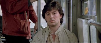 Movie still from “Bad Timing: A Sensual Obsession” (1980), directed by Nicolas Roeg – A person on a bus wearing a jacket; Close Up shot, Low angle