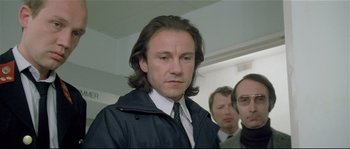 Movie still from “Bad Timing: A Sensual Obsession” (1980), directed by Nicolas Roeg – A person wearing a jacket and tie; Close Up shot, Low angle