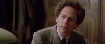 Movie still from “Bad Timing: A Sensual Obsession” (1980), directed by Nicolas Roeg – A person wearing a suit and tie; Close Up shot, Over the shoulder angle