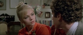 Movie still from “Bad Timing: A Sensual Obsession” (1980), directed by Nicolas Roeg – A woman in a red shirt is talking to a man; Close Up shot, Over the shoulder angle