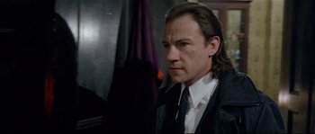 Movie still from “Bad Timing: A Sensual Obsession” (1980), directed by Nicolas Roeg – A person wearing a suit and tie; Close Up shot, Low angle