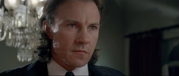 Movie still from “Bad Timing: A Sensual Obsession” (1980), directed by Nicolas Roeg – A person wearing a suit and tie; Close Up shot, Low angle