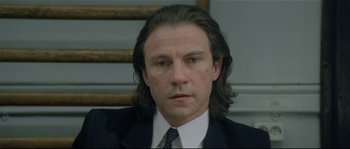 Movie still from “Bad Timing: A Sensual Obsession” (1980), directed by Nicolas Roeg – A person wearing a suit and tie; Close Up shot, High angle