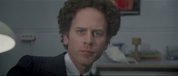 Movie still from “Bad Timing: A Sensual Obsession” (1980), directed by Nicolas Roeg – A person wearing a suit and tie; Close Up shot, Low angle