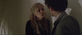 Movie still from “Bad Timing: A Sensual Obsession” (1980), directed by Nicolas Roeg – A young woman looking at a young man in front of a wall; Close Up shot, Over the shoulder angle