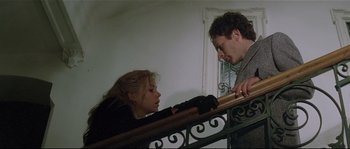 Movie still from “Bad Timing: A Sensual Obsession” (1980), directed by Nicolas Roeg – A man and a woman on the stairs; Medium shot, Low angle