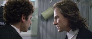 Movie still from “Bad Timing: A Sensual Obsession” (1980), directed by Nicolas Roeg – Two men face each other in a room; Close Up shot, Over the shoulder angle