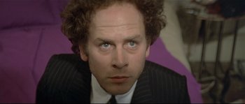 Movie still from “Bad Timing: A Sensual Obsession” (1980), directed by Nicolas Roeg – A person wearing a suit and tie; Close Up shot, Low angle