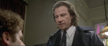 Movie still from “Bad Timing: A Sensual Obsession” (1980), directed by Nicolas Roeg – A person wearing a suit and tie; Close Up shot, Low angle