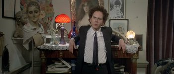 Movie still from “Bad Timing: A Sensual Obsession” (1980), directed by Nicolas Roeg – A man in a suit and tie in front of a desk; Medium shot, Over the shoulder angle