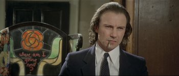 Movie still from “Bad Timing: A Sensual Obsession” (1980), directed by Nicolas Roeg – A person wearing a suit and tie; Close Up shot, Low angle