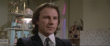 Movie still from “Bad Timing: A Sensual Obsession” (1980), directed by Nicolas Roeg – A person wearing a suit and tie; Close Up shot, Low angle