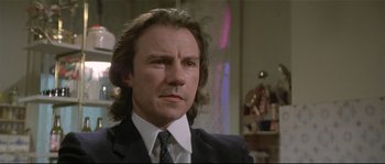 Movie still from “Bad Timing: A Sensual Obsession” (1980), directed by Nicolas Roeg – A person wearing a suit and tie; Close Up shot, Low angle