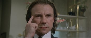 Movie still from “Bad Timing: A Sensual Obsession” (1980), directed by Nicolas Roeg – A man with long brown hair wearing a suit; Close Up shot, Low angle