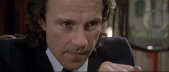 Movie still from “Bad Timing: A Sensual Obsession” (1980), directed by Nicolas Roeg – A person wearing a suit and tie; Close Up shot, Low angle