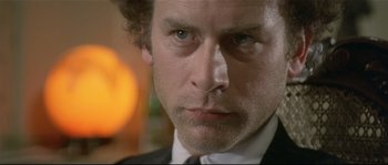 Movie still from “Bad Timing: A Sensual Obsession” (1980), directed by Nicolas Roeg – A person wearing a suit and tie; Close Up shot, Low angle