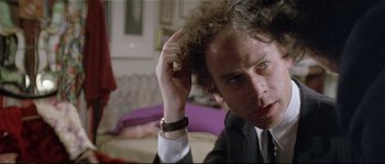 Movie still from “Bad Timing: A Sensual Obsession” (1980), directed by Nicolas Roeg – A person holding his hand up to his head; Close Up shot, Over the shoulder angle