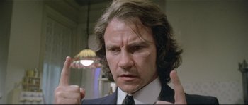 Movie still from “Bad Timing: A Sensual Obsession” (1980), directed by Nicolas Roeg – A person wearing a suit and tie; Close Up shot, Low angle