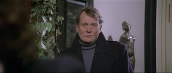 Movie still from “Bad Timing: A Sensual Obsession” (1980), directed by Nicolas Roeg – A person wearing a coat; Close Up shot, Over the shoulder angle