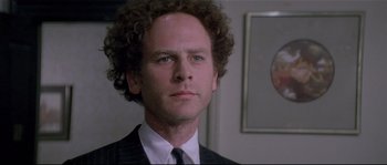 Movie still from “Bad Timing: A Sensual Obsession” (1980), directed by Nicolas Roeg – A person wearing a suit and tie; Close Up shot, Over the shoulder angle