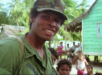 A man wearing a hat and smiling for the camera