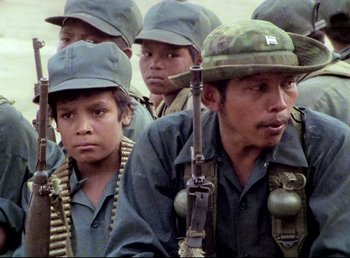 A group of young men wearing hats and holding guns