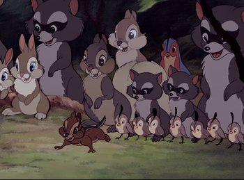 Movie still from “Bambi” (1942), directed by David Hand – A group of cartoon characters gathered together in a field; Wide shot, High angle